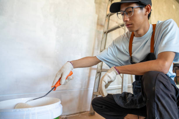 asian worker painting a house, so happy - home decoration stock pictures, royalty-free photos & images