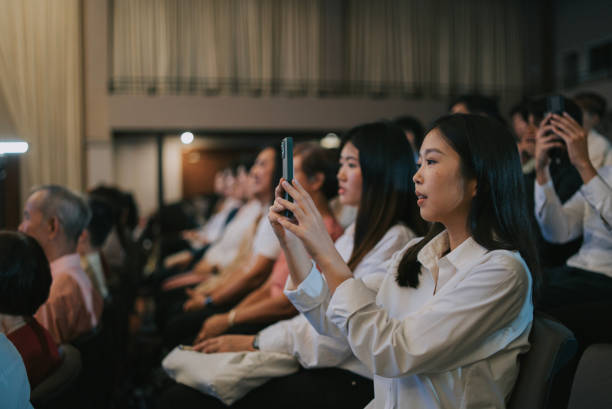 asian young adult filming with smart phone at concert - concert stock pictures, royalty-free photos & images