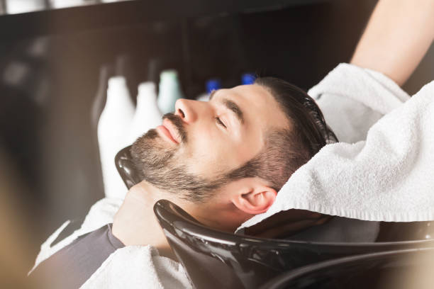 at the hairdresser washing hair - hairstyle stock pictures, royalty-free photos & images
