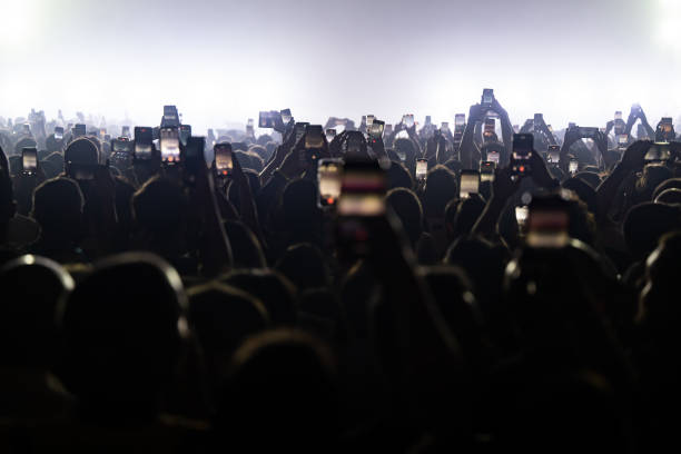 Audience addends Annalisa's concert filming the scene with their smartphone on April 13, 2024 in Naples, Italy.