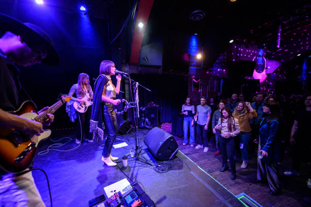 audience dancing to live band performing on stage at small venue - concert stock pictures, royalty-free photos & images