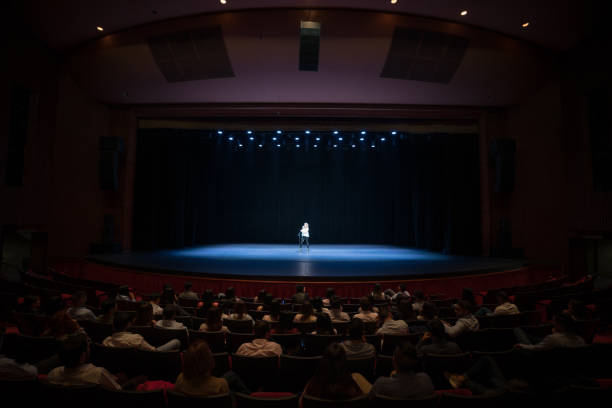 audience enjoying a singing performance on stage - concert stock pictures, royalty-free photos & images