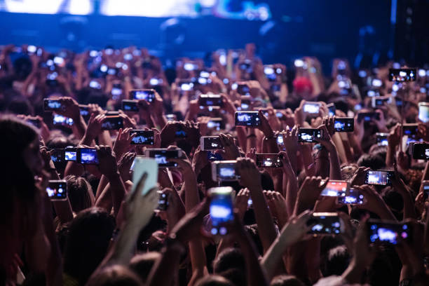 Audience with cell phones record the Now United concert at Espaco das Americas on November 20, 2019 in Sao Paulo, Brazil.