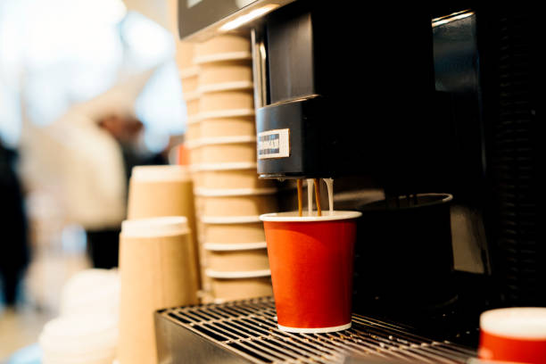 automatic coffee machine in a self-service restaurant, preparing various types of coffee hot drinks. red paper disposable coffee cups to go. fast food cafeteria - junk food stock pictures, royalty-free photos & images