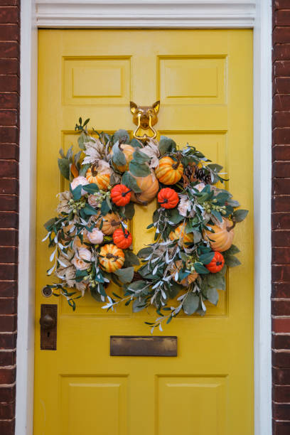 autumn wreath adorns yellow front door - home decoration stock pictures, royalty-free photos & images