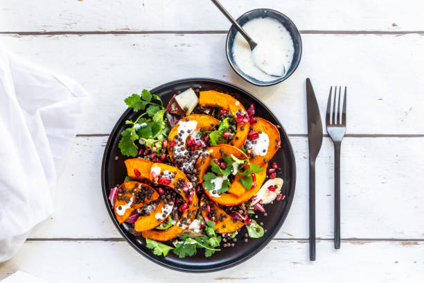 autumnal salad with fried pumpkin, lentils, radicchio, pomegranate seeds, leaf salad and parsley with dressing - food stock pictures, royalty-free photos & images