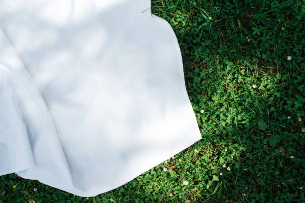 background with a white blanket on the grass. picnic. empty space for design. mockup for food and drinks. - garden decoration stock pictures, royalty-free photos & images