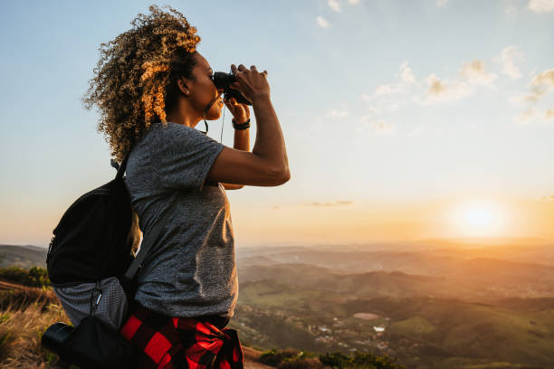 backpacker woman using binoculars - travel stock pictures, royalty-free photos & images