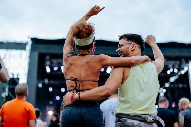 backshot of couple dancing at concert. - concert stock pictures, royalty-free photos & images