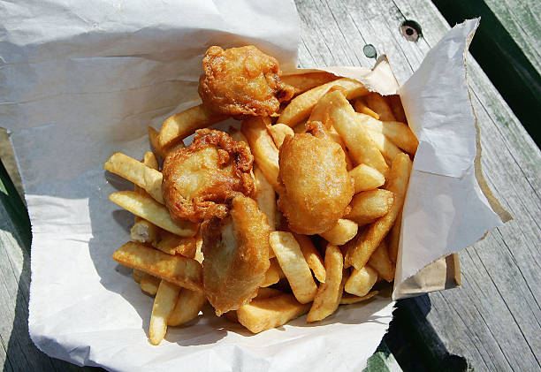 Bag of deep fried oysters and chips, a meal considered a local delicacy and available from many take-away outlets throughout New Zealand is seen on...