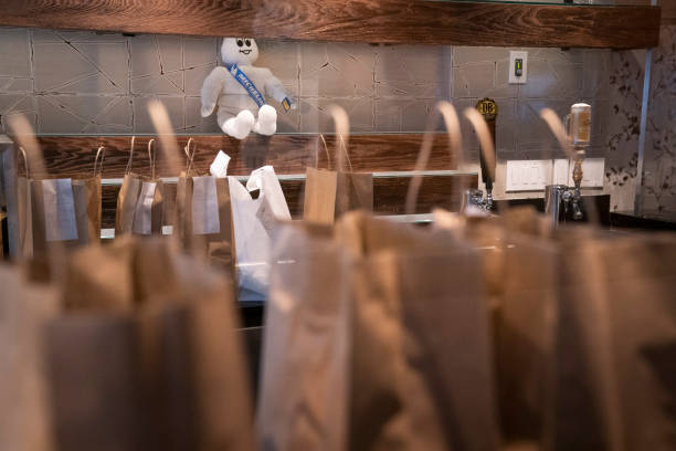 Bags of take out order are seen on the bar of the Sushi Taro sushi restaurant on May 2, 2020 in Washington, DC. Owners of the Michelin-starred...