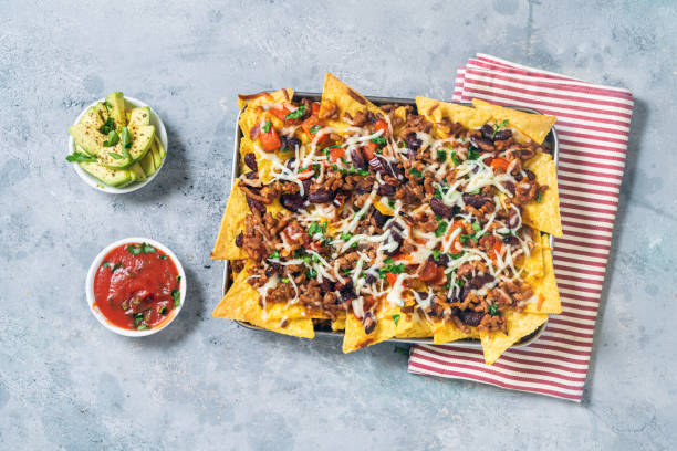 baked nachos with chili con carne mexican food - junk food stock pictures, royalty-free photos & images