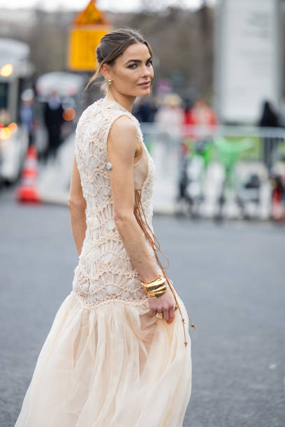 Bambi Northwood Blyth wears beige laced sleeveless dress, golden bracelet outside Zimmermann during the Womenswear Fall/Winter 2025/2026 as part of...