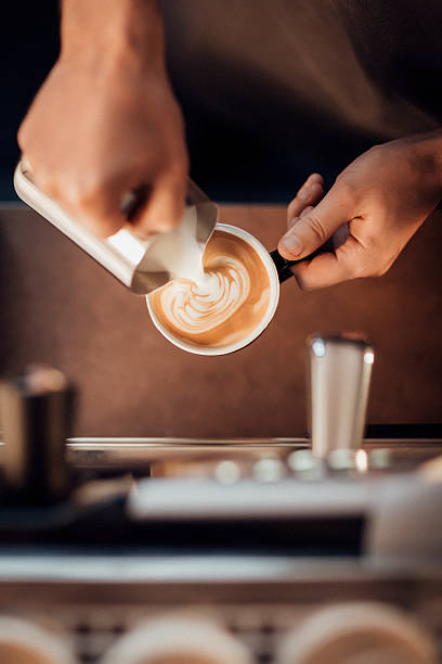 barista making a latte milk coffee with milk froth - coffee stock pictures, royalty-free photos & images