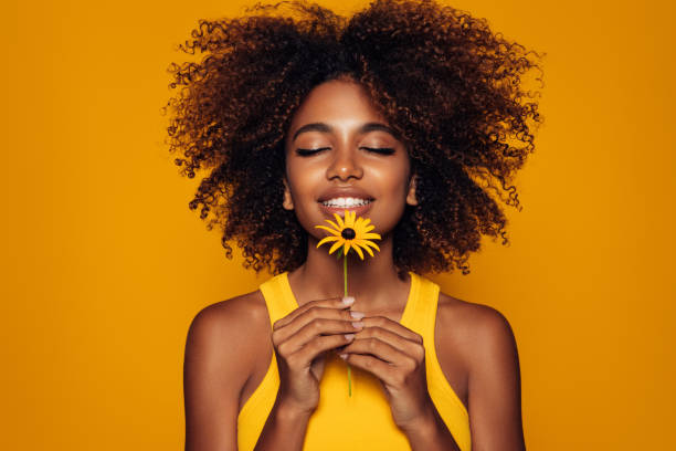 beautiful afro woman with a flower - fashion stock pictures, royalty-free photos & images