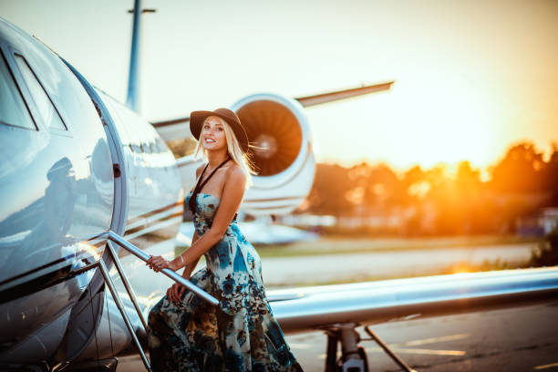 beautiful blonde girl boarding a private airplane at sunset - fashion stock pictures, royalty-free photos & images