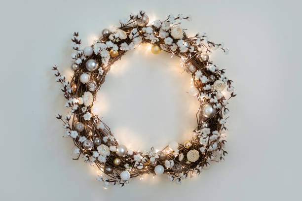 beautiful christmas wreath with burning garland hanging on the white wall. - home decoration stock pictures, royalty-free photos & images