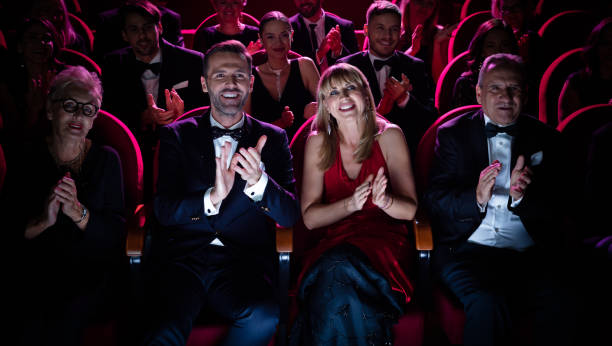 beautiful couple applauding while watching opera - concert stock pictures, royalty-free photos & images