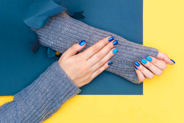 beautiful female hands holding yellow cup. manicure with blue nail polish. cozy concept, copy space - nails art stock pictures, royalty-free photos & images