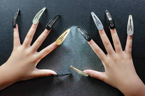 beautiful hands with long fingernail art using hair clips - nails art stock pictures, royalty-free photos & images