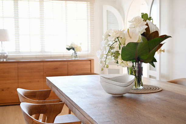 beautiful home dining table with vase of flowers - home decoration stock pictures, royalty-free photos & images