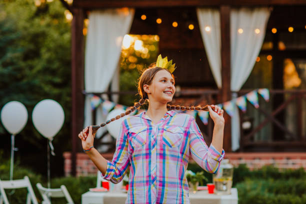 beautiful teen girl with mouth braces posing against decorated birthday zone - garden decoration stock pictures, royalty-free photos & images