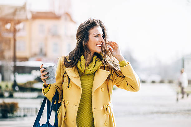 beautiful woman walking outdoors on a sunny day - junk food stock pictures, royalty-free photos & images