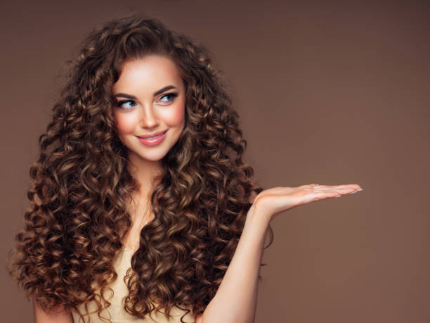beautiful woman with voluminous curly hairstyle - hairstyle stock pictures, royalty-free photos & images