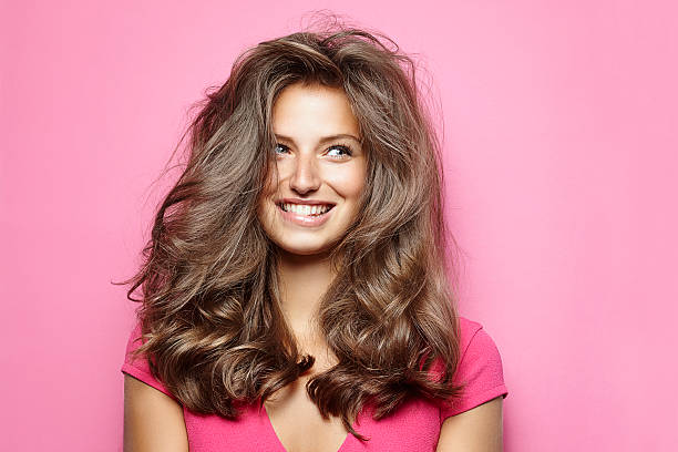beautiful young woman with messy hair - hairstyle stock-fotos und bilder