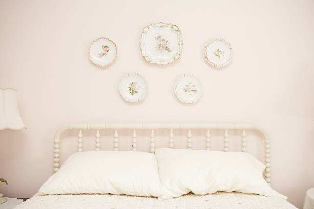 bedroom with porcelain hanging on wall above bed - home decoration stock pictures, royalty-free photos & images