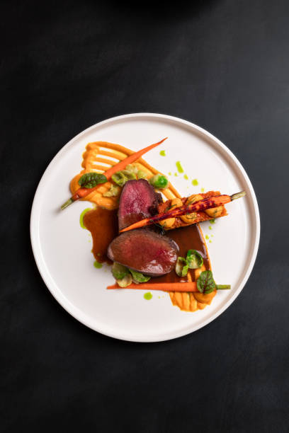 beef deer steak filet with gravy, carrot puree and carrot cake served with red wine at michelin star gourmet restaurant - food stock pictures, royalty-free photos & images
