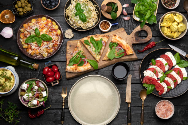 big dinner table with italian food, pizzas and pastas - food stock pictures, royalty-free photos & images