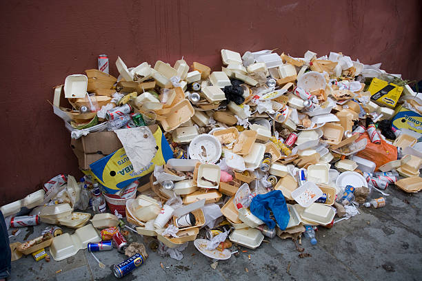 Big pile of garbage, mostly from fast-food packaging, lies on a street during the annual Notting Hill Carnival.
