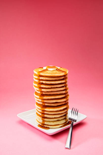 big tall stack of pancakes on pink background - food stock pictures, royalty-free photos & images