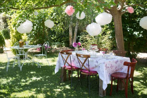 birthday table set-up in garden decorated with laterns - garden decoration stock pictures, royalty-free photos & images