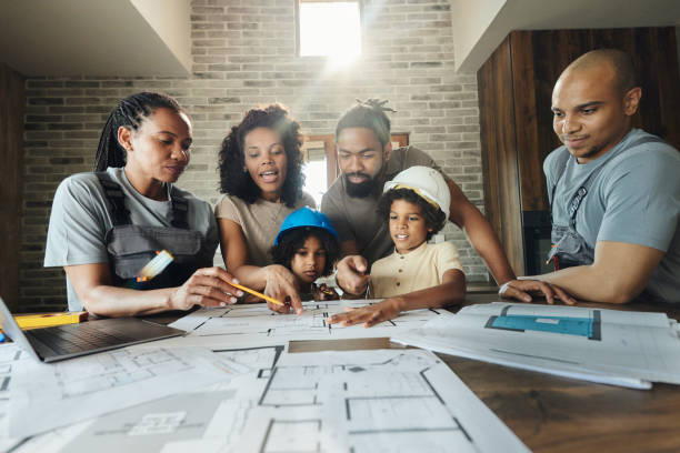 black family and manual workers analyzing blueprints at home. - home decoration stock pictures, royalty-free photos & images
