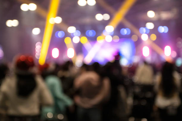 blurred background image of people enjoying music at night celebrate christmas party - concert stock pictures, royalty-free photos & images