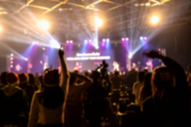 blurred background of people at christmas party - concert stock pictures, royalty-free photos & images