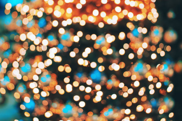 bokeh image of christmas tree. blurred background made with decorated fir tree. - home decoration stock-fotos und bilder