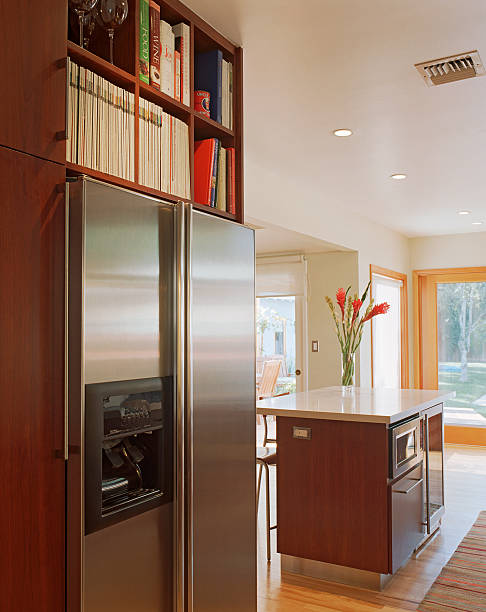 bookshelves over stainless steel refrigerator - home decoration stock pictures, royalty-free photos & images