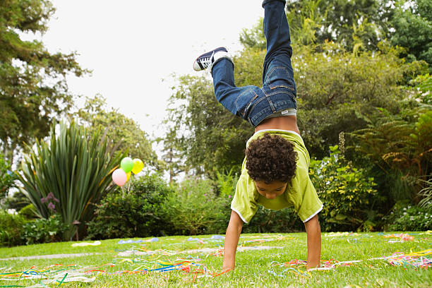 boy doing handstand - garden decoration stock pictures, royalty-free photos & images