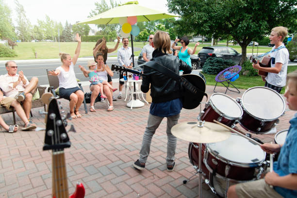 boy's band in concert in family driveway in summer. - concert stock pictures, royalty-free photos & images
