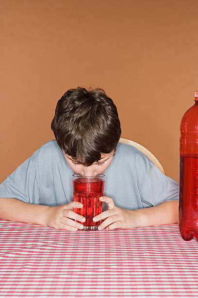 boy smelling fizzy drink - junk food stock pictures, royalty-free photos & images