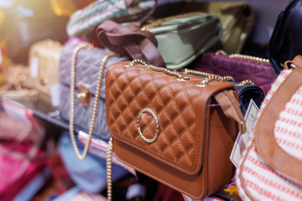 brand new designer handbags on shelves of a fashion store for sale. - fashion stock pictures, royalty-free photos & images