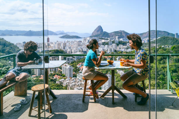 brazilian couple on terrace, sugar loaf mountain in background - food stock pictures, royalty-free photos & images