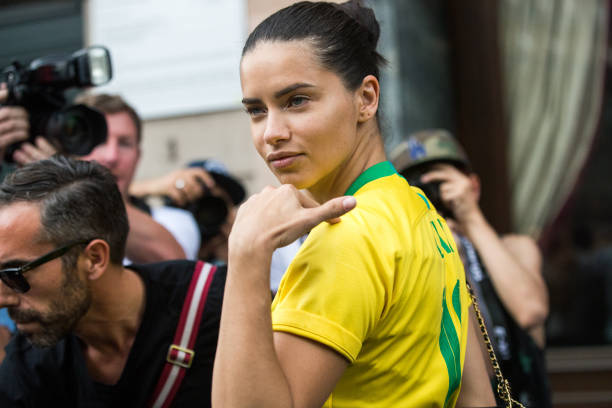 Brazilian super model Adriana Lima wears a "Lima" Brasil soccer/football jersey during Couture Fall 2018 Fashion Week on July 2, 2018 in Paris,...