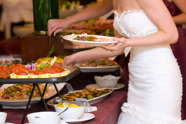 bride getting food from buffet. - food stock pictures, royalty-free photos & images