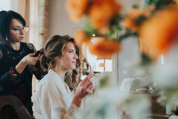bride preparing for wedding with hairstylist - hairstyle stock pictures, royalty-free photos & images