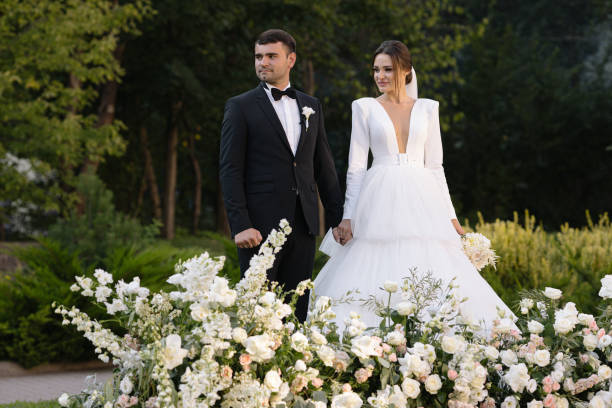 brides in love are holding hands against the background of a beautiful landscape. - garden decoration stock pictures, royalty-free photos & images