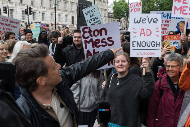 British celebrity chef and healthy food campaigner Jamie Oliver speaks during a protest outside Downing Street against the government's U-turn on its...